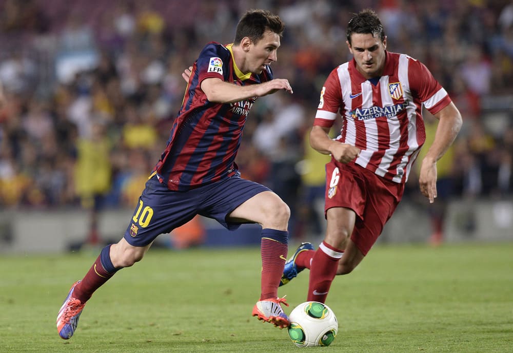 FC Barcelona`s Lionel Messi from Argentina duels for the ball against Atletico Madrid`s Koke Resurreccion during a final Spanish Super Cup at the Camp Nou stadium in Barcelona, Spain.