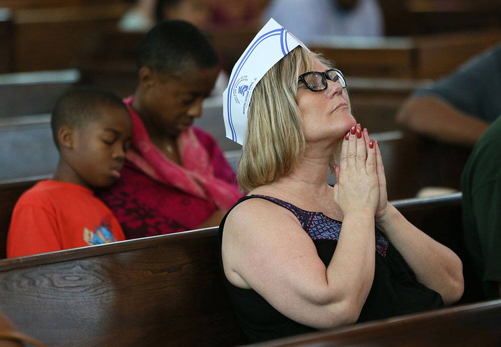 Diana Yates, joins in a prayer during a bell ringing ceremony at Ebenezer Baptist Church in commemoration of when Martin Luther King Jr. delivered his