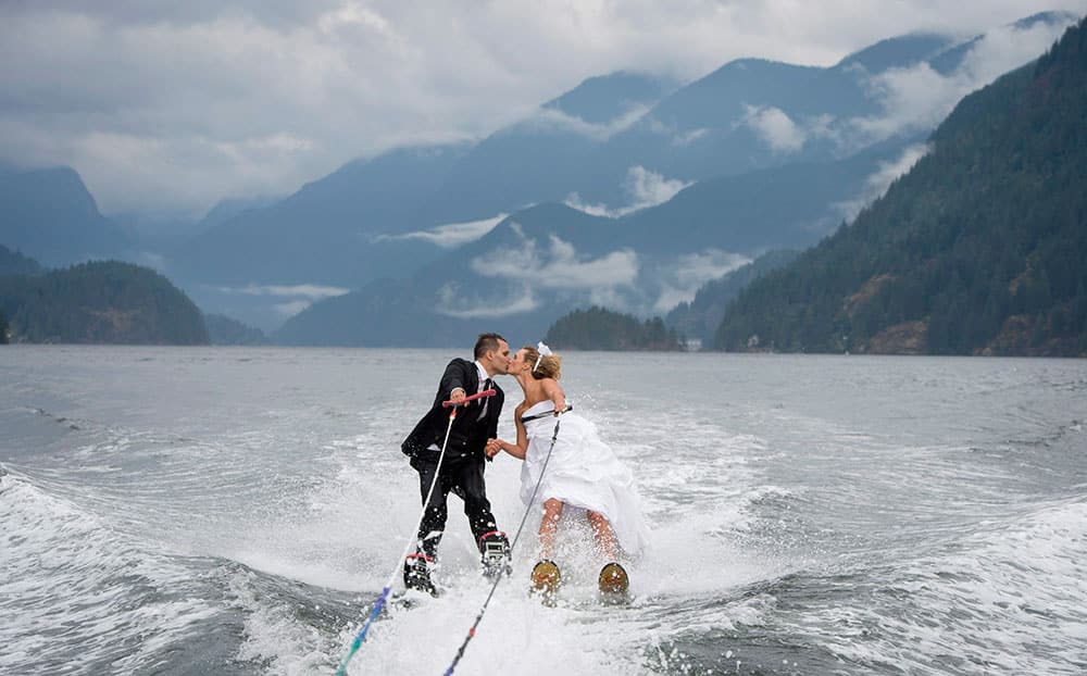 Newly weds Cam Auge and Caylee Wasilenko share a kiss as they water ski in Bedwell Bay in North Vancouver, British Columbia.