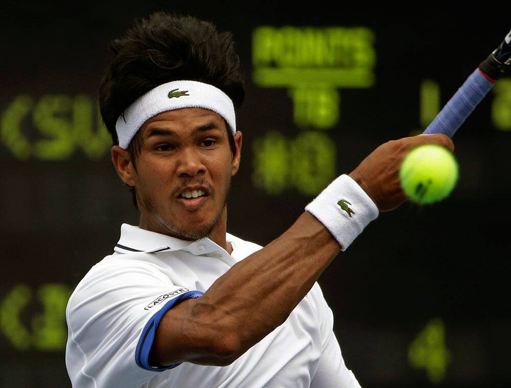 Somdev Devvarman, of India, returns a shot to Lukas Lacko, of Slovakia, during the first round of the 2013 US Open tennis tournament.