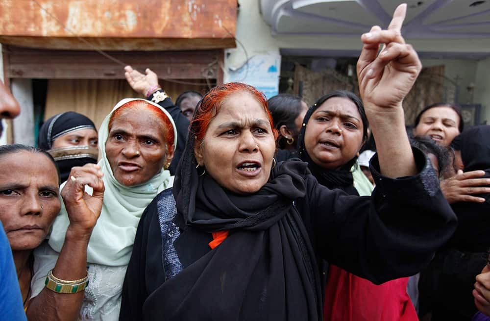 Angry residents of flood affected areas argue with authorities at a relief camp following heavy monsoon rains in Allahabad.