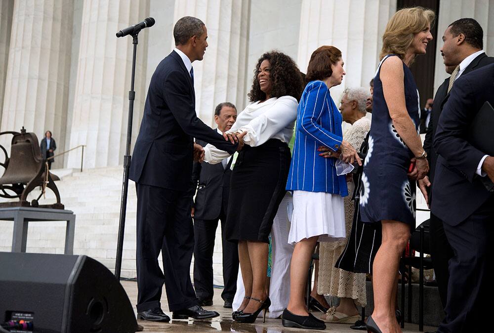 President Barack Obama talks with Oprah Winfrey during a ceremony commemorating the 50th anniversary of the March on Washington, at the Lincoln Memorial in Washington.
