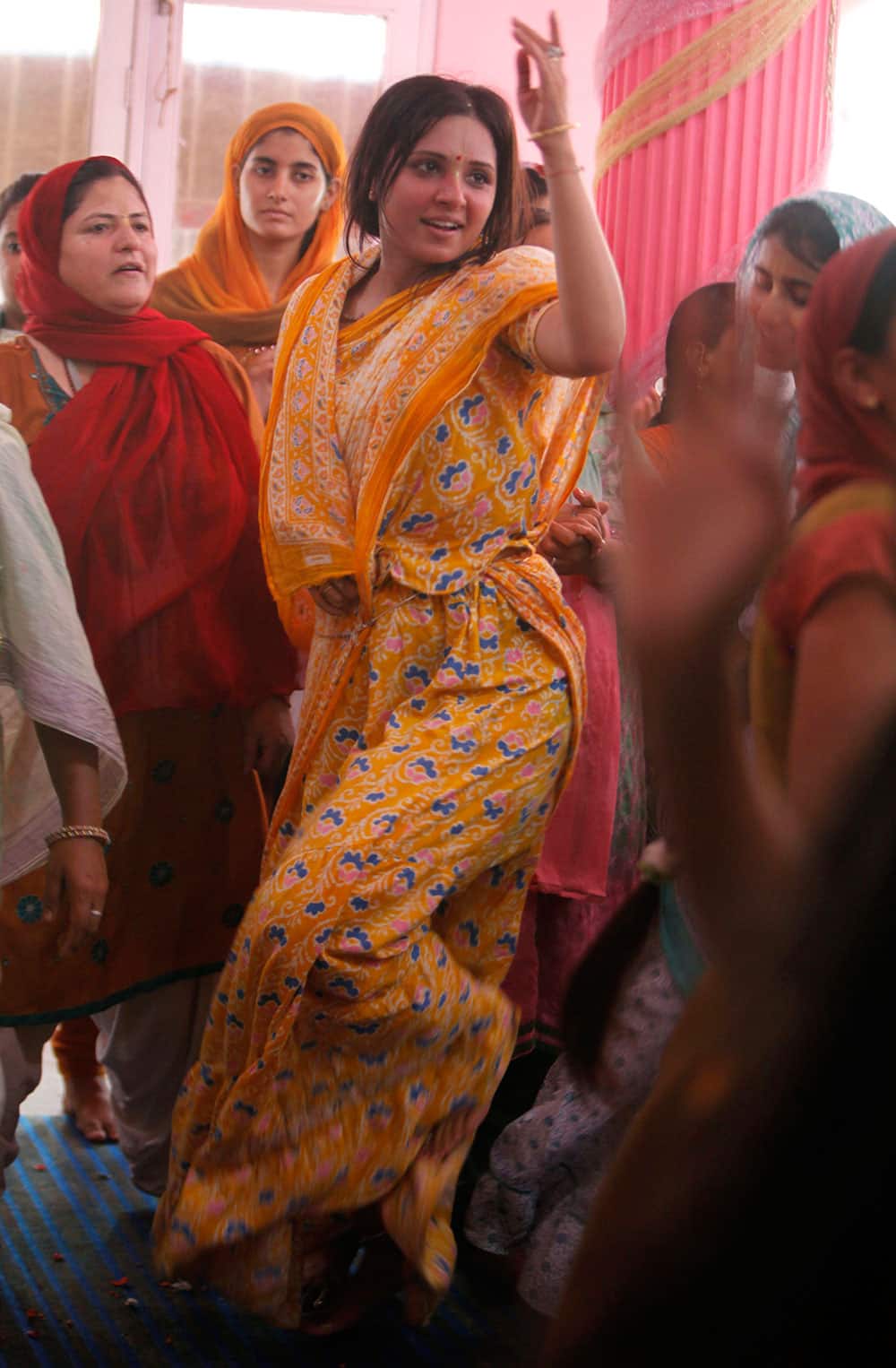 Devotees dance as they worship Lord Krishna as part of Janamashtami celebrations at the ISKON temple in Jammu, India.