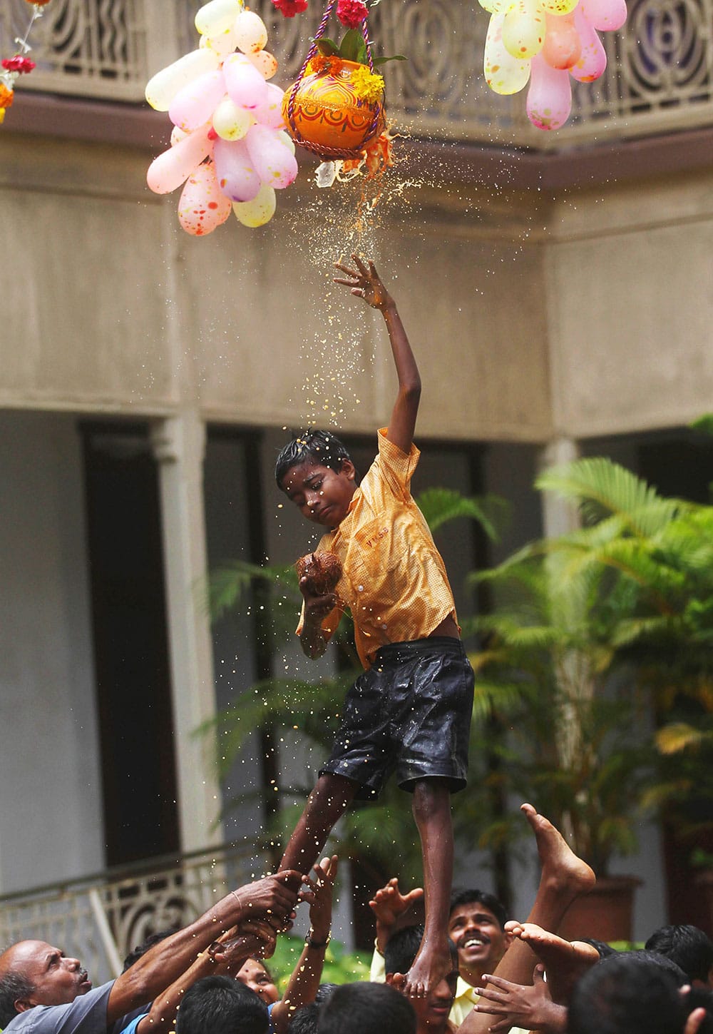 A blind child tries to reach an earthen pot filled with curd hung high during celebrations to mark ‘Janmashtami’ at the Victoria school for the blind in Mumbai.