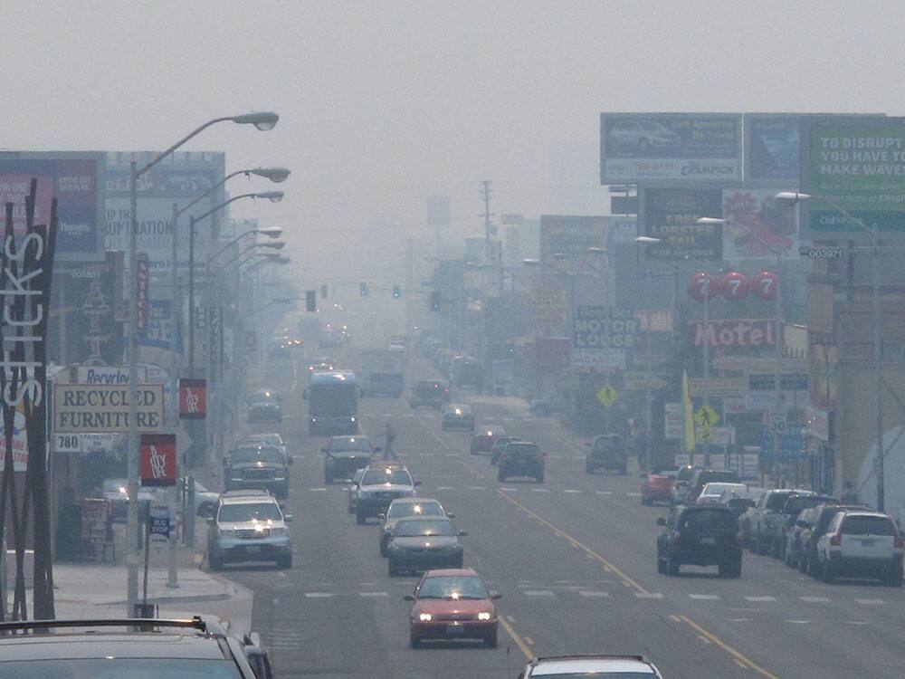 A smoky haze from a huge California wildfire burning more than 150 miles away hangs over Virginia Street in Reno, Nev.