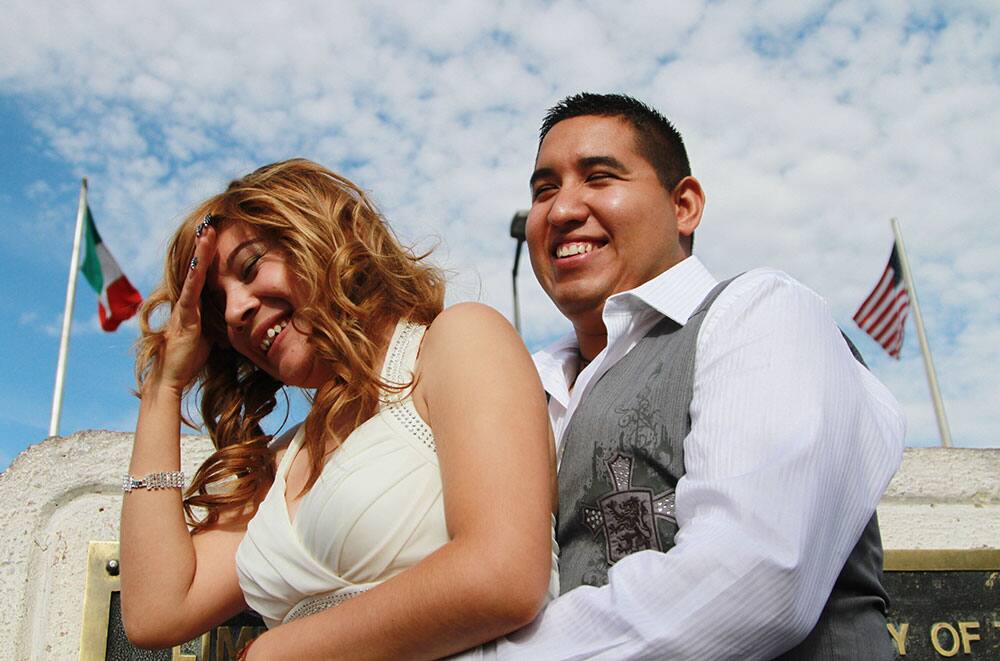 US citizen Edgar Falcon hugs Maricruz Valtierra of Mexico at the US-Mexico border where they were married in El Paso, Texas.