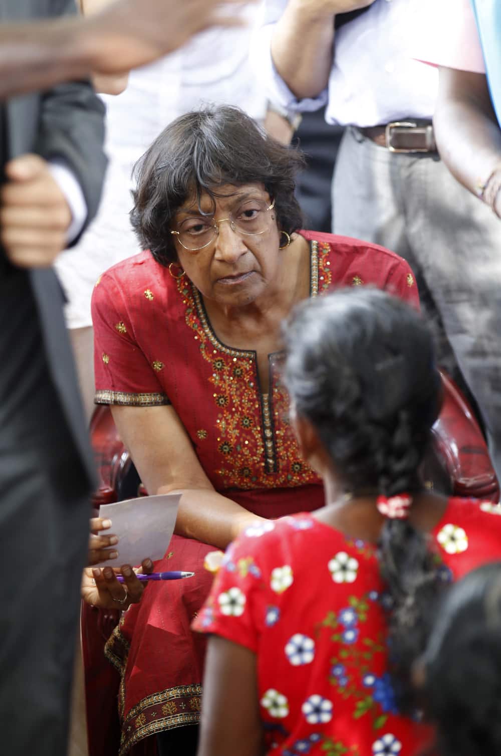 U.N. High Commissioner for Human Rights Navi Pillay listens to an ethnic Tamil war survivor during her visit to Mullivaikkal, Sri Lanka.