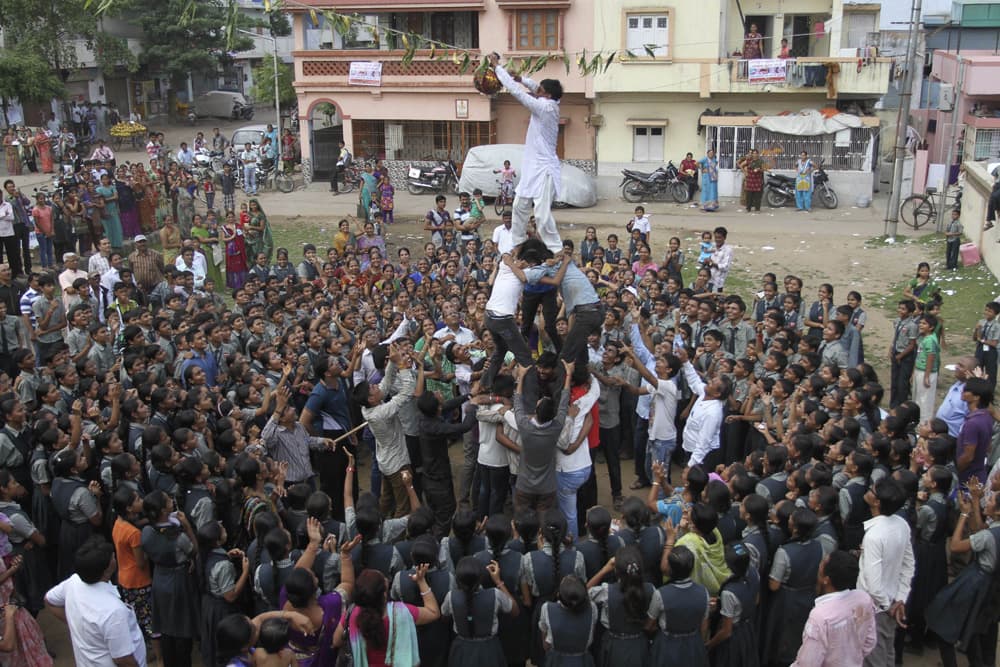 Students form a human pyramid to break an earthen pot during the Janmashtami festival, in Ahmadabad.