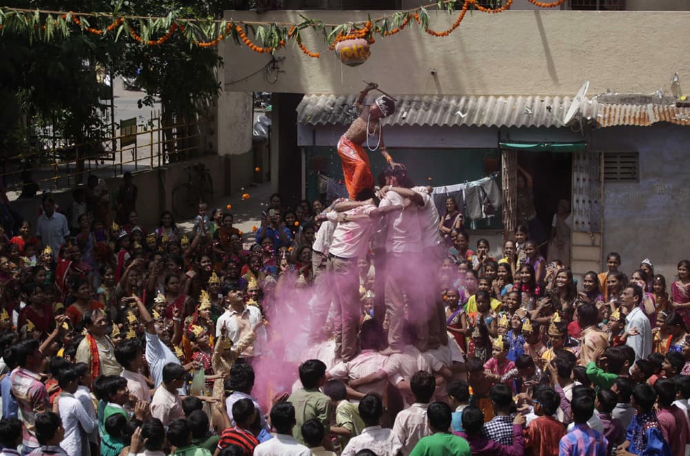 Students form a human pyramid to break an earthen pot during the Janmashtami festival, in Ahmadabad.