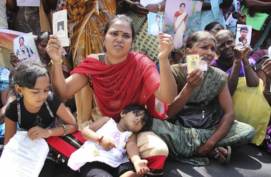 Family members of disappeared Tamil people holding pictures of their relatives protest during the visit of U.N. High Commissioner for Human Rights Navi Pillay, in Jaffna, Sri Lanka.