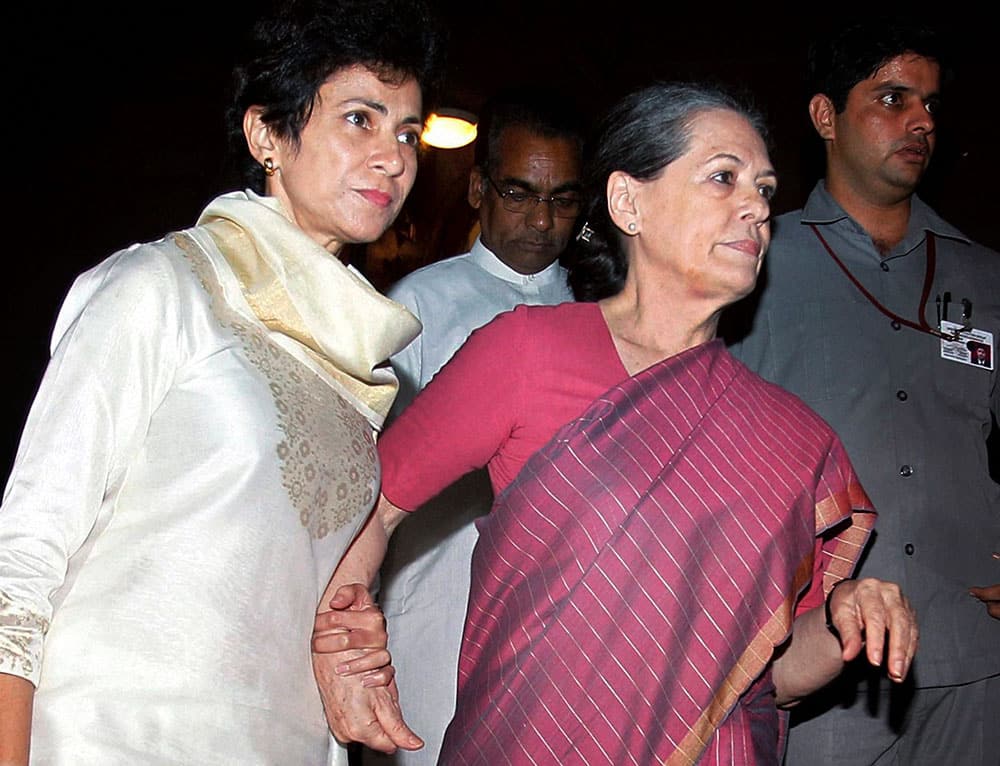 Indian minister for Social Justice and Empowerment Kumari Selja escorts Chairman of ruling United Progressive Alliance and Congress party president Sonia Gandhi, right, as they walk out of Indian Parliament House during the debate on National Food Security Bill 2013, in New Delhi