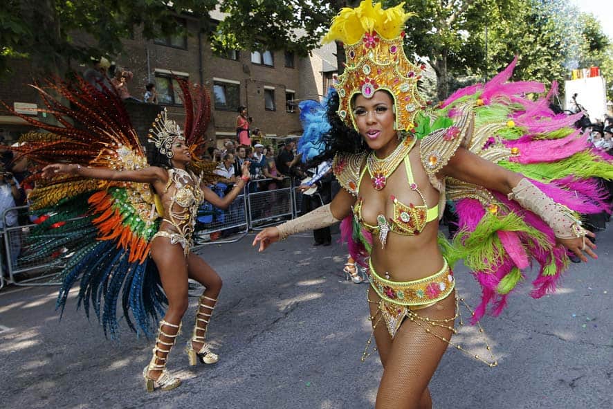 Revellers dance as they parade through the streets during the Notting Hill Carnival in London.