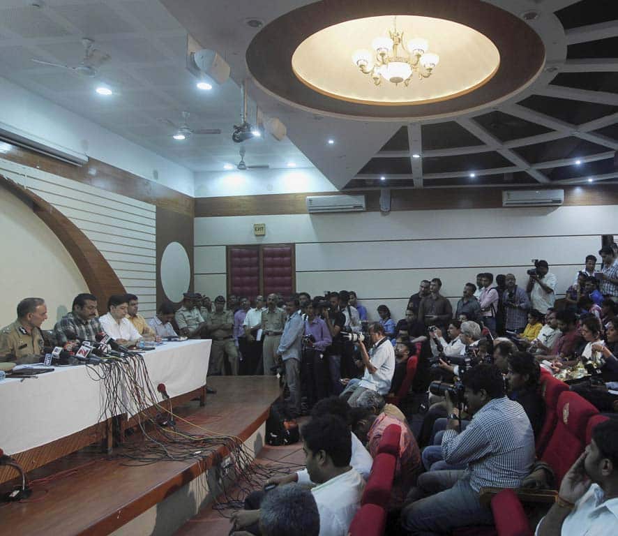 Journalists attend a press conference addressed by Mumbai Police Commissioner Satyapal Singh, left, in Mumbai.