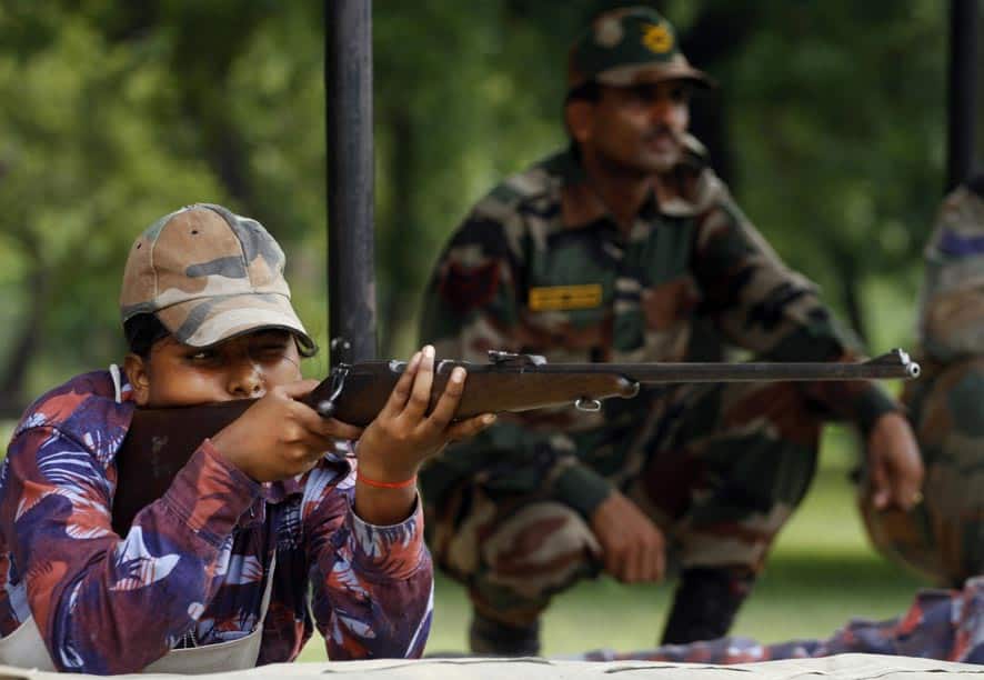 An Indian girl cadet of the National Cadet Corps (NCC) takes aim during a training session in arms in Allahabad.