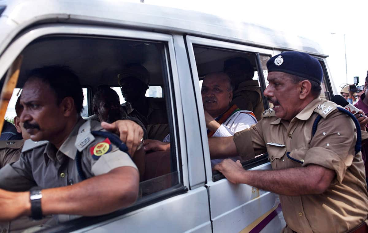 Policemen detain leader of the nationalist organization Vishva Hindu Parishad (VHP) or World Hindu Council Pravin Togadia, center, in Ayodhya.