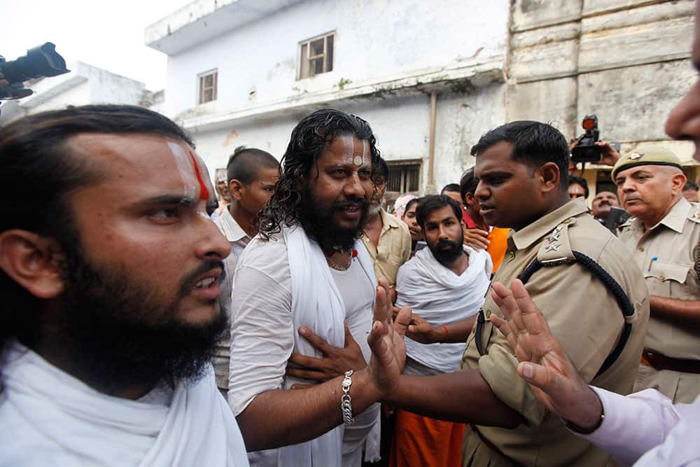 Policemen stop activists of the nationalist organization Vishva Hindu Parishad (VHP) or World Hindu Council in Ayodhya.