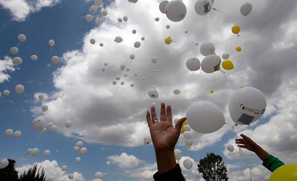 People release balloons with messages printed on them during an event to honor those who have died from cancer organized by The Youth Against Cancer Foundation in Quito, Ecuador.