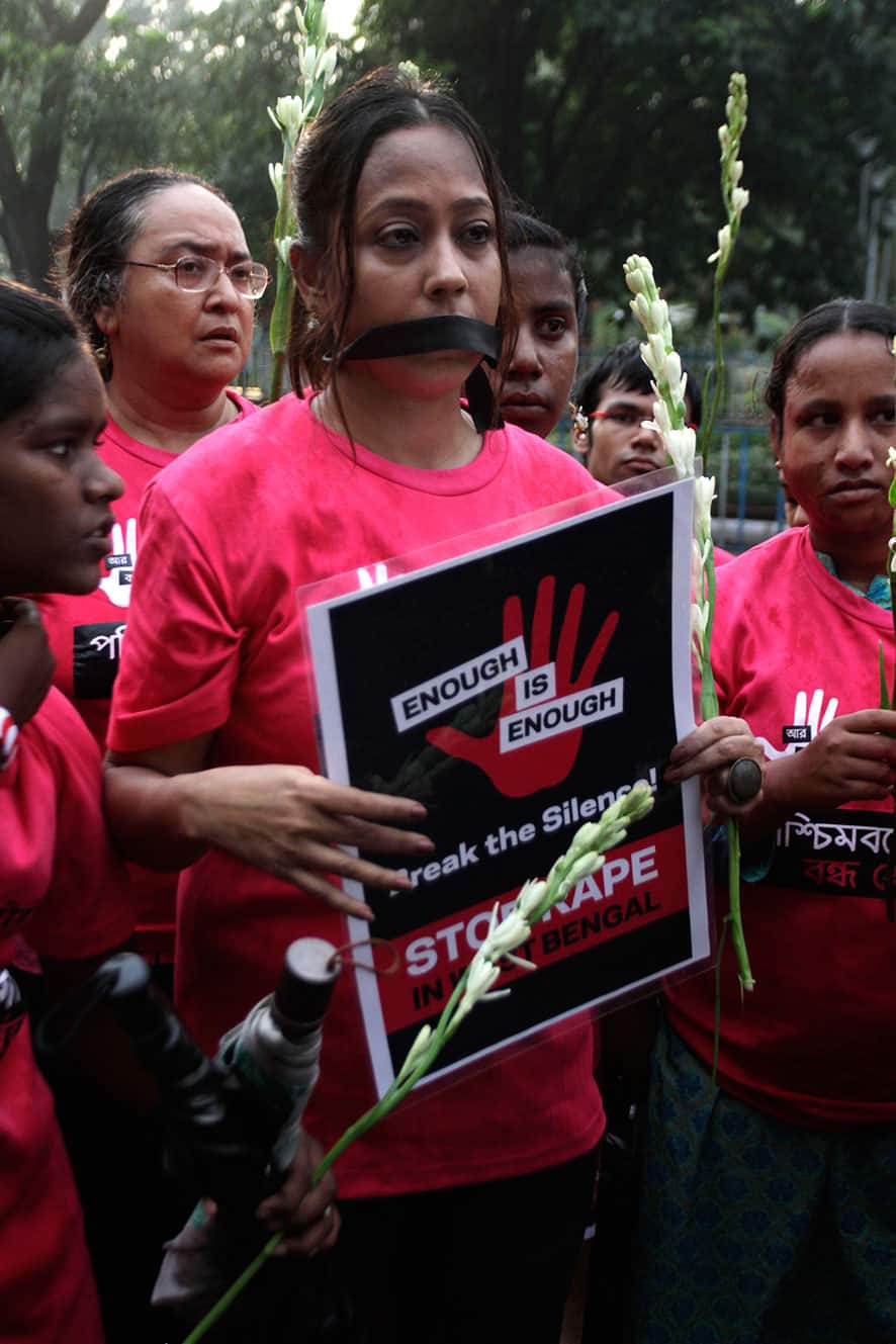 Activists of Avaaz, a campaign network, protesting the rape of a 22 year old photojournalist in Mumbai, walk in a silent rally in Kolkata.