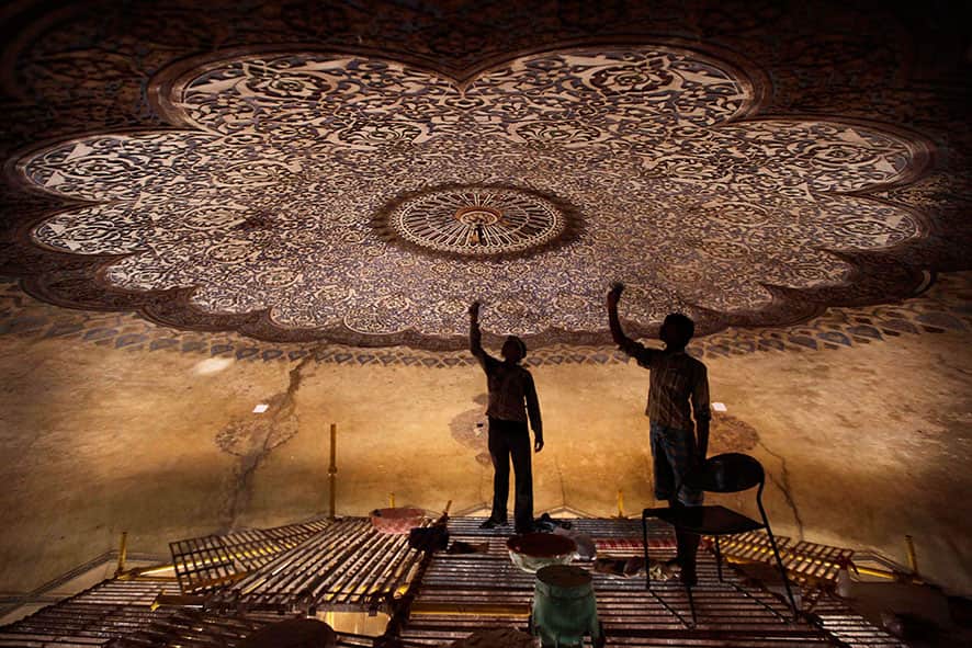Laborers work to renovate the Neela Gumbad, or Blue Tomb, as part of a project for the creation of a mammoth 1,200-acre park in New Delhi.