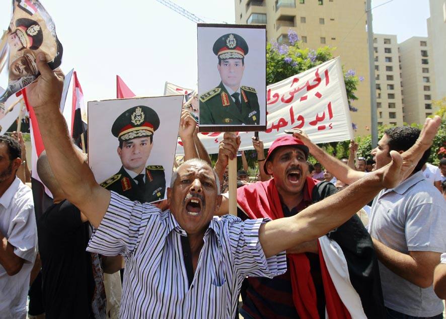 Egyptians citizens who live in Lebanon chant slogans against the Muslim Brotherhood as they hold a supporting banner and posters of Egyptian Army Chief Lt. Gen. Abdel-Fattah el-Sissi during a rally to show their solidarity with the Egyptian army and police, in front the Egyptian Embassy in Beirut, Lebanon.