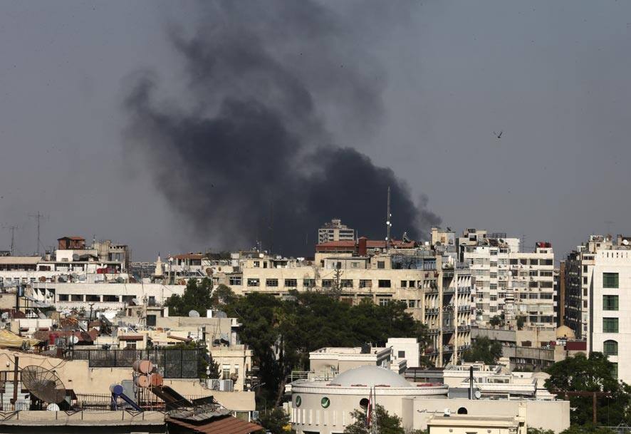 Black columns of smoke rise from heavy shelling in the Jobar neighborhood, east of Damascus, Syria.
