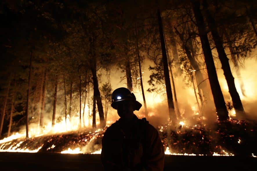 A firefighter watches for spot fires during a burnout operation while battling the Rim Fire near Yosemite National Park, Calif.