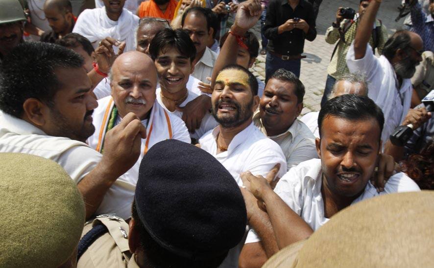 Activists of the Hindu right-winged Vishwa Hindu Parishad, or World Hindu Council (VHP) scuffle with Indian policemen before getting detained at Ayodhya.