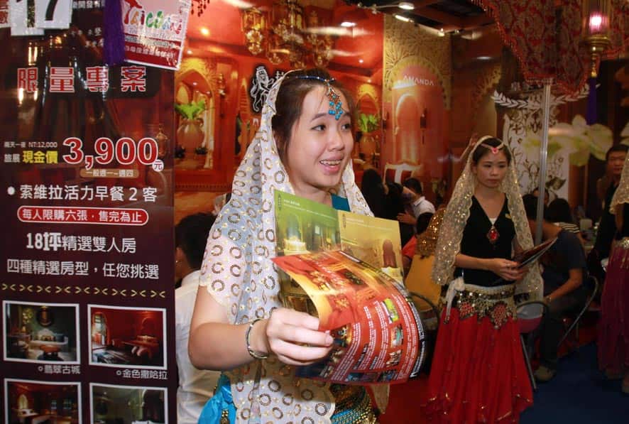Taiwanese women in Indian sari at an Indian booth to promote hotels for tourists to India during Taiwan International Tourism Expo in Taipei, Taiwan.