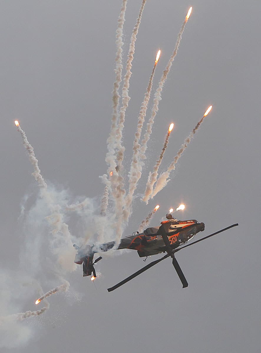 A Dutch AH-64 Apache helicopter fires flares during a performance at the International Air Show in Radom, Poland.