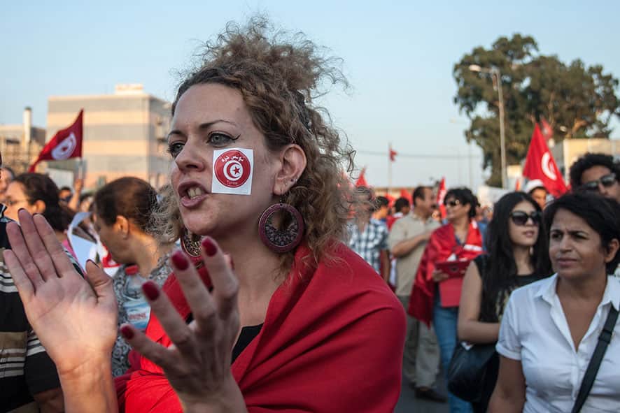 People demonstrate against Tunisia`s Islamist-led government, in front of the Constituent Assembly headquarters in Tunis, Tunisia.