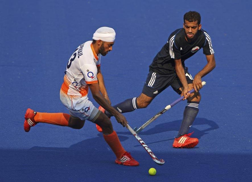 India`s Gurmail Singh, left, and Oman`s Al-Saadi Salah Nasser Ahmad battle for the ball during the 9th men`s Asia Cup field hockey tournament in Ipoh, Malaysia.
