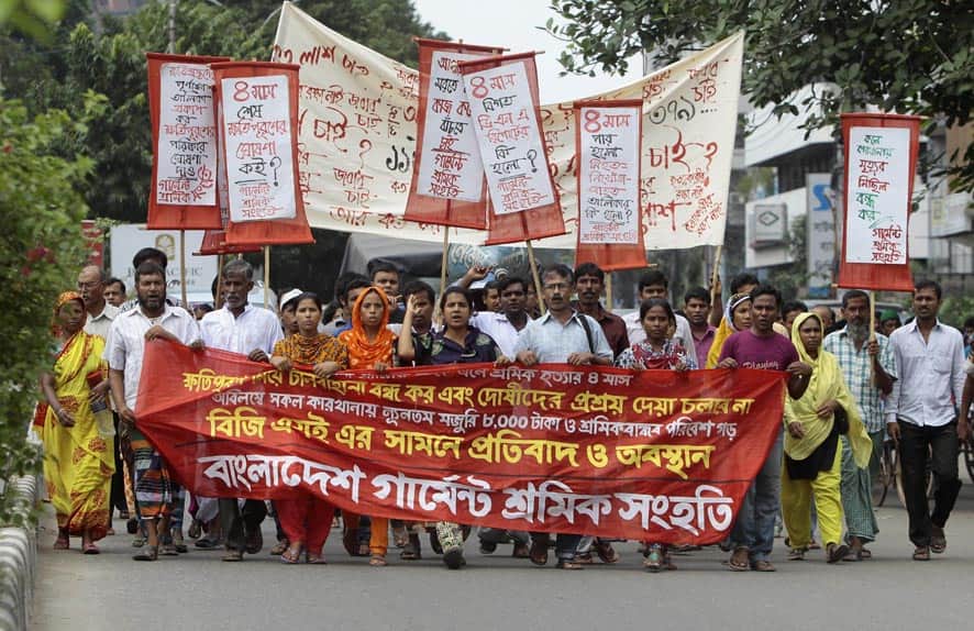 Bangladeshi garment workers, activists and relatives of workers participate in a protest marking the four-month anniversary of the Rana Plaza building that collapsed killing over 1,000 people, outside the Bangladesh Garment Manufacturers and Export Association (BGMEA) office building in Dhaka, Bangladesh