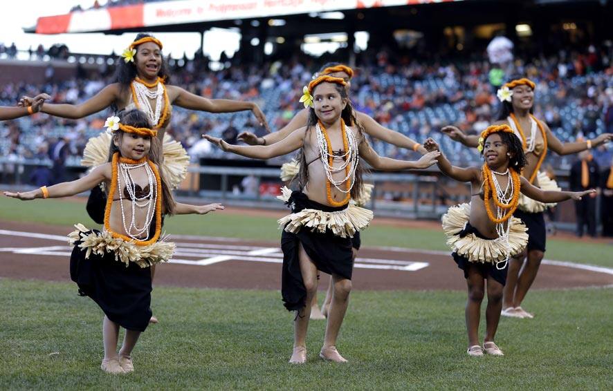 A group of dancers with the group Ehulani Otea perform during a tribute to Polynesian Heritage Night before the start of a baseball game between the San Francisco Giants and the Pittsburgh Pirates, in San Francisco.