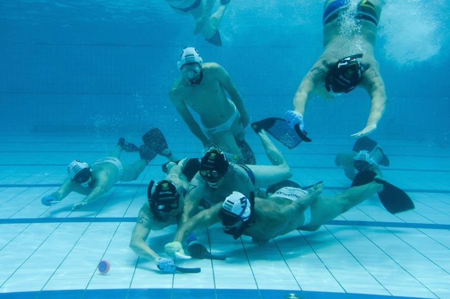 South African, black cap, and Hungarian players fight for the puck during their match in men’s qualifying round of 18th CMAS Underwater Hockey World Championship in Eger, 127 kms northeast of Budapest, Hungary.