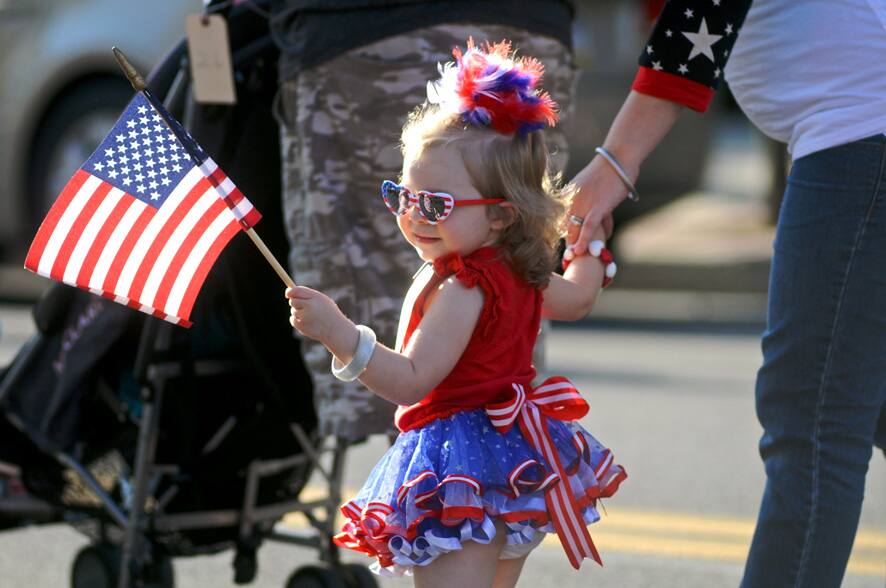 Ava Russell, walks with her mother Ashley on Centre Street in the Baby Parade during Youth Day as part of the borough sesquicentennial celebration in Mahanoy City, Pa.