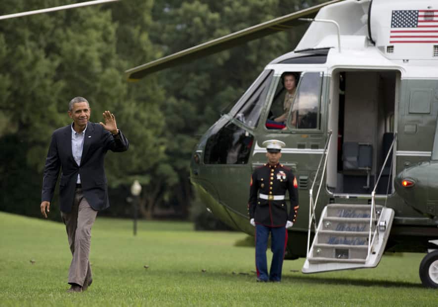 President Barack Obama waves to media as he walks across the South Lawn of the White House from Marine One helicopter in Washington, as he returns from the second day of his two-day bus tour to discuss college affordability in New York and Pennsylvania.