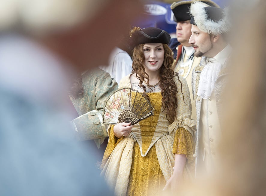 People dressed in Baroque costumes wait in front of the city hall during the opening of the Baroque Festival in Gotha, central Germany.