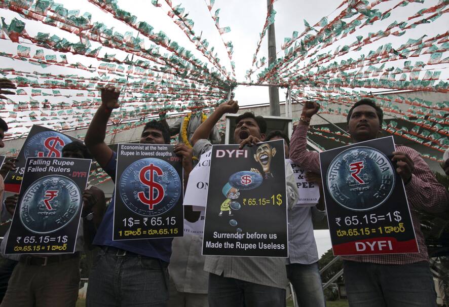 Activists of Democratic Youth Federation of India (DYFI) shout slogans during a protest against the government over the fall of the Indian rupee, in Hyderabad.