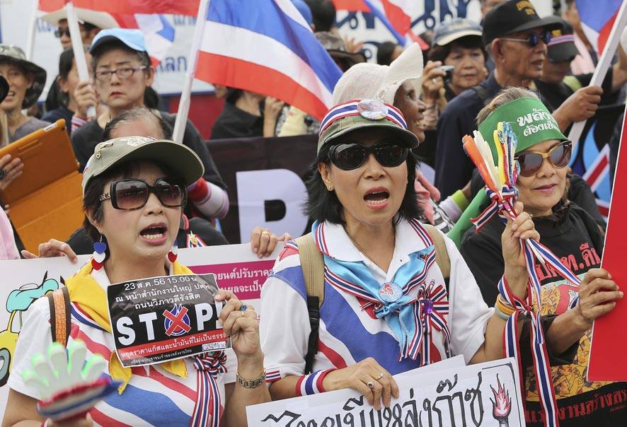 Protesters chant slogans during a demonstration outside the headquarters of the Petroleum Authority of Thailand (PTT) in Bangkok, Thailand.