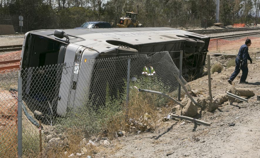 Salvage towing crews remove an overturned tour bus carrying gamblers to a casino on the 210 Southern California freeway injuring more than 50 people on board in Irwindale, Calif.