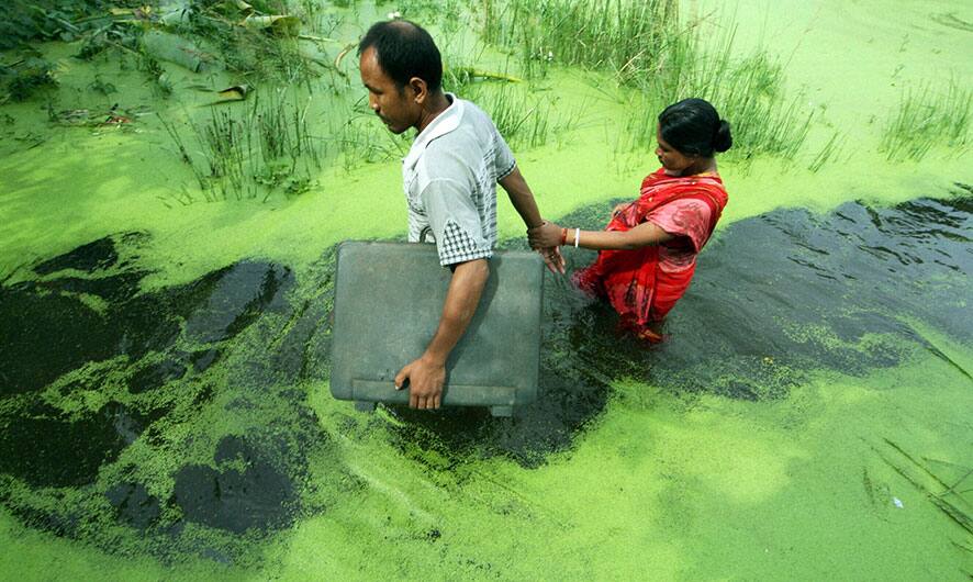 A couple wades through a waterlogged area following monsoon rains in Kolkata. India`s monsoon season, which runs from June through September, bring rains that are vital to agriculture but also cause floods and landslides.