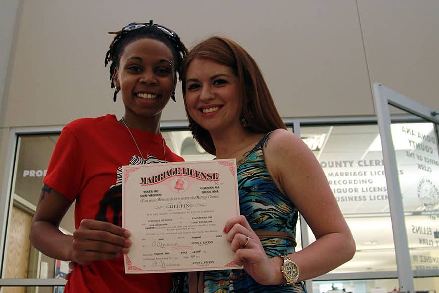 Sarah Santos and Jamonica Hudgin pose for a picture with their marriage license at the Dona Ana County Clerk`s Office in Las Cruces, New Mexico.