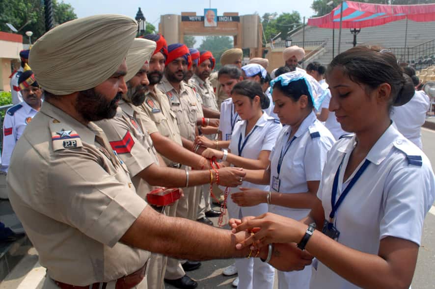 Girls tie rakhis on the wrists of Punjab policemen as a symbolic gesture to mark