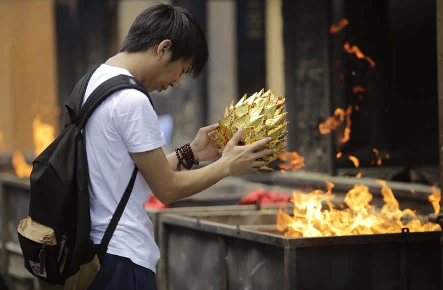 A man offers prayers to his deceased relatives on the Ghost Festival at Longhua Temple in Shanghai. Ghost Festival is held to worship ancestors in China.
