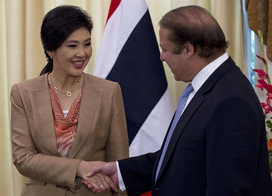 Pakistani Prime Minister Nawaz Sharif, right, shakes hands with his Thai counterpart Yingluck Shinawatra prior to their meeting at the Prime Minister House in Islamabad, Pakistan.