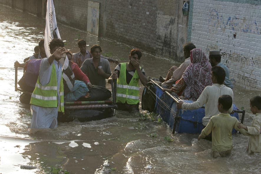 Volunteers of Pakistani religious group of Jamaat-ud-Dawwa help stranded villagers to move to safer ground in suburbs of Lahore.