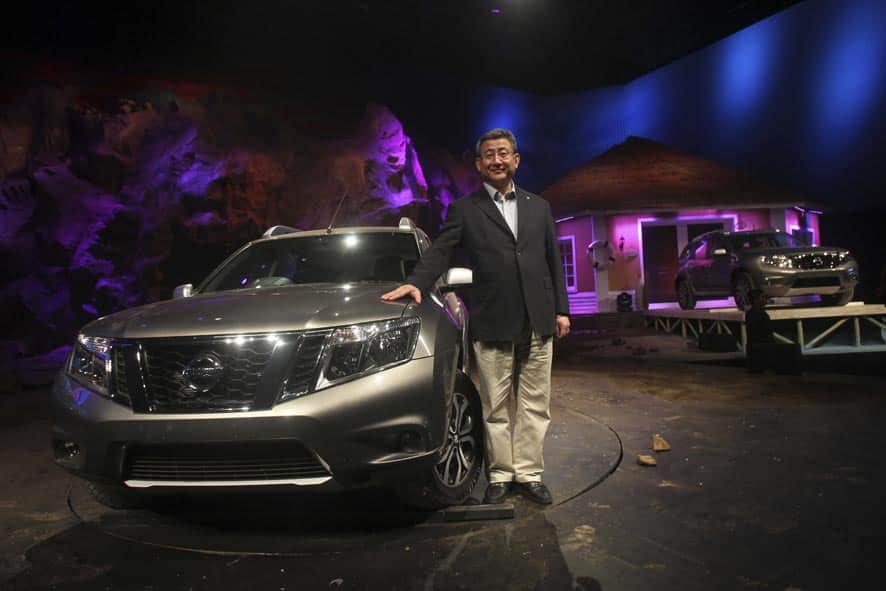 Nissan India Operations President Kenichiro Yomura poses with a new Terrano premium compact SUV during an unveiling ceremony in Mumbai.