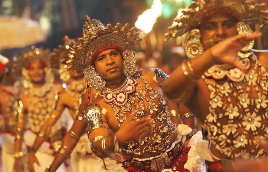 Sri Lankan traditional dancers perform during an annual Buddhist procession in Kandy. Hundreds of thousands of Buddhists throng the hill-capital every year to venerate Buddha`s tooth relic which is taken on a parade on decorated elephants with traditional dancers and drummers performing.
