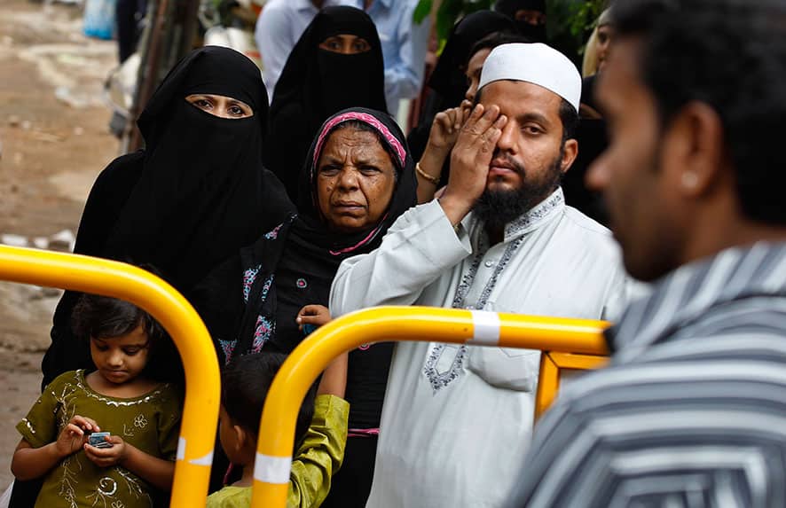 A Muslim family watches rescuers work at the site of an under construction building, which collapsed partially in Bangalore.