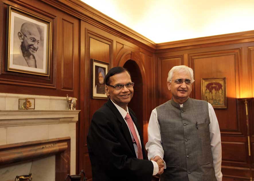 Salman Khurshid, right, welcomes his Sri Lankan counterpart Gamini Peiris at his office, in New Delhi.